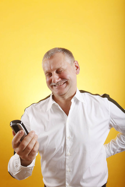 portrait of a handsome man using a mobile phone - Fotó, kép
