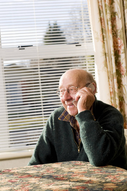 Senior man texting and calling with mobile phone - 写真・画像