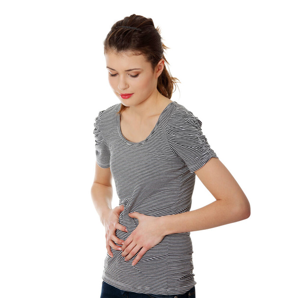 Teen woman with stomach issues,isolated on white - Fotografie, Obrázek