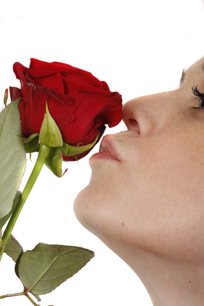 charming valentine smelling a red rose - Fotó, kép