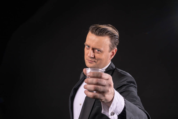 the man in the tuxedo offers a glass of water by type of Gatsby - Fotoğraf, Görsel