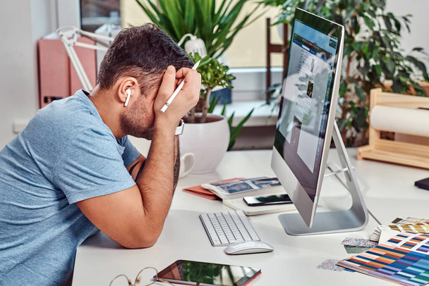 Man feels tired while working in office - Photo, Image