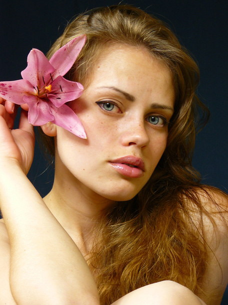 Young girl with a lily in hairs - Foto, immagini