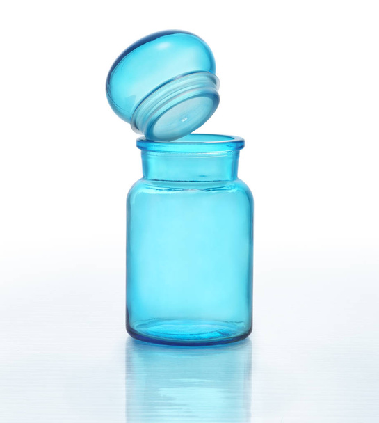 Blue glass bottle with a glass stopper opened. Clipping path - 写真・画像