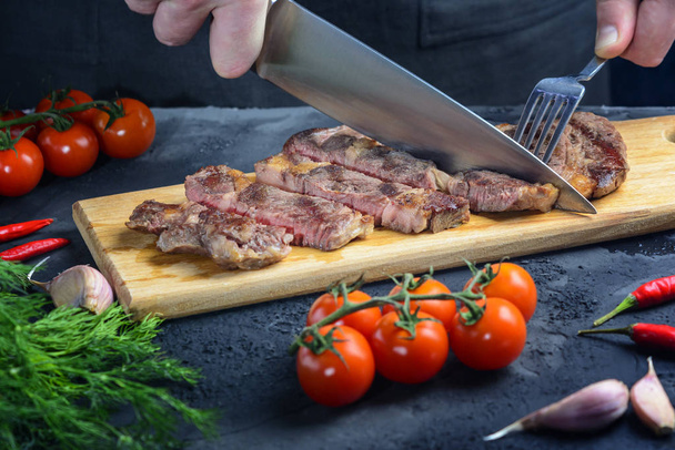The steak is cut into portions. Meat with blood. Tasty restaurant dish - Фото, изображение