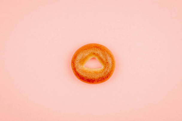 Little  bagel  on pink background. - Photo, Image