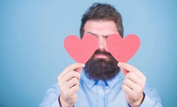 Making man feel loved. Man bearded hipster with heart valentine card. Celebrate love. Guy attractive beard and mustache in romantic mood. Feeling love. Dating and relations concept. Happy in love - Φωτογραφία, εικόνα