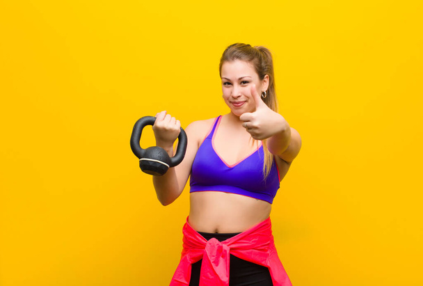 young blonde woman with a dumbbell. sport concept - Фото, зображення