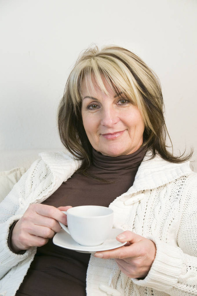 portrait of a middle-aged woman with a white coffee cup - Foto, immagini