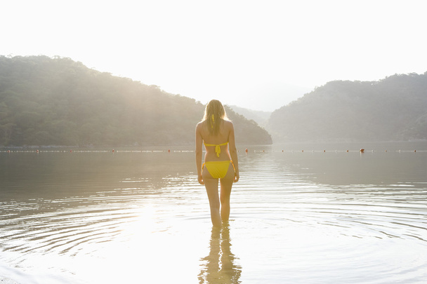 Woman at edge of lake - Zdjęcie, obraz