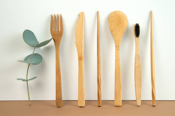 Eco friendly bamboo cutlery set and eucalyptus leaves on a white background. Zero waste concept. - Foto, afbeelding
