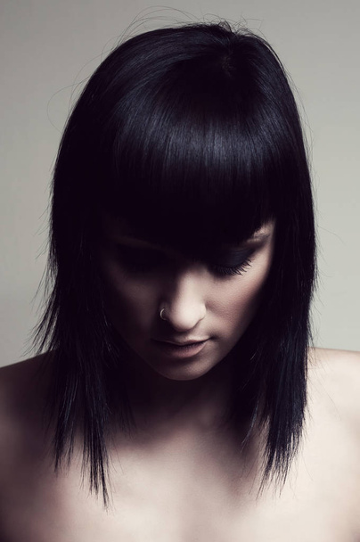 Portrait of a beautiful brunette looking down, inspiring sadness. - Foto, Imagem