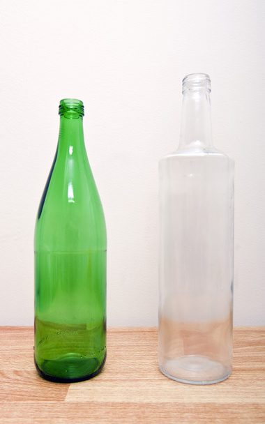 Green glass bottle and clear glass bottle - Photo, image
