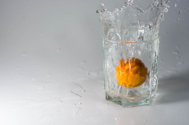 Mandarin in a glass with water - Foto, imagen