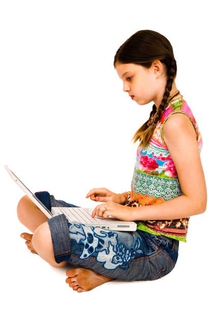 Caucasian girl using a laptop and posing isolated over white - Photo, Image