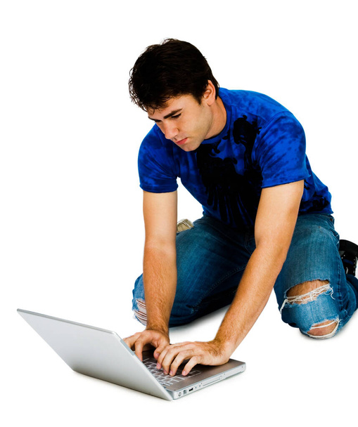Man using a laptop and posing isolated over white - Fotoğraf, Görsel