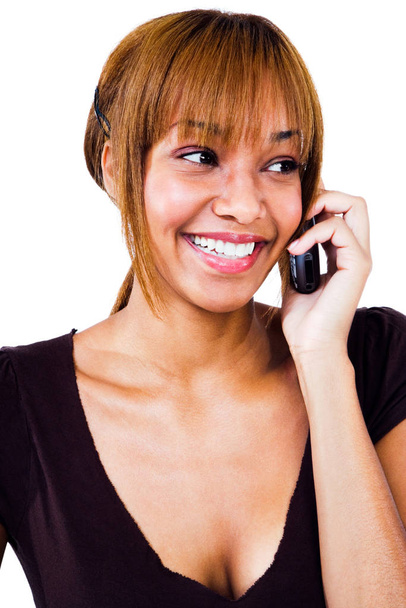 Smiling woman talking on a mobile phone isolated over white  - Фото, изображение