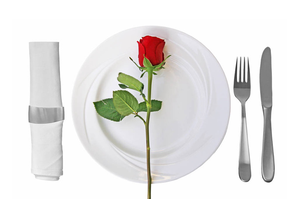 Place setting on whtie plate and red rose on white Background - Foto, immagini
