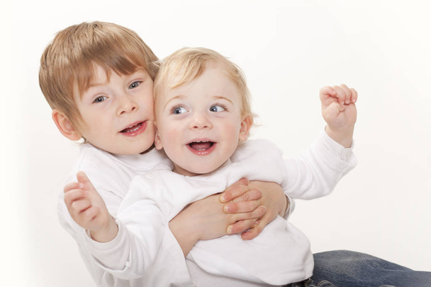 one year and three year old brothers on white background - 写真・画像