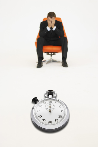 Worried businessman with stopwatch - Foto, immagini