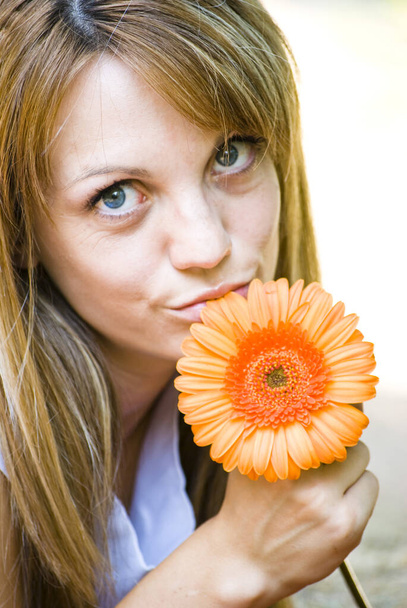beautiful young blonde woman with flower - Fotó, kép