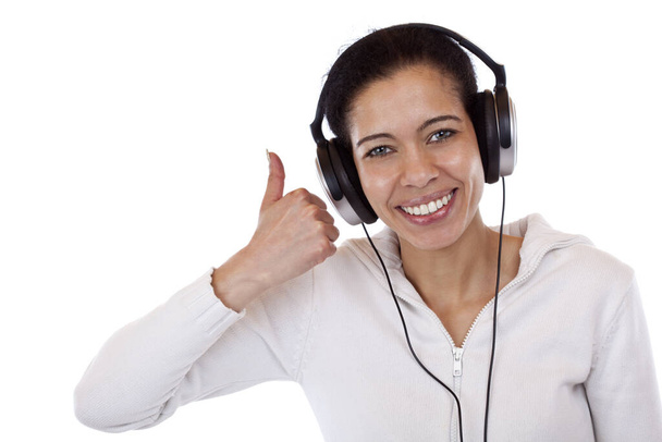 attractive,laughing black woman with headphones showing thumbs. isolated on white background. - 写真・画像
