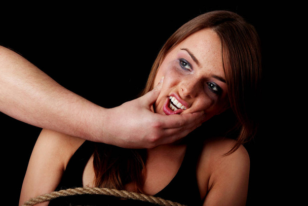 Emotional portrait of abused woman isolated on black   - Photo, Image
