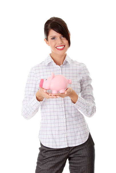 Businesswoman holding piggy bank. Isolated on white background  - Фото, изображение