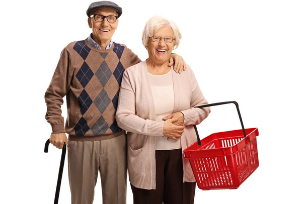 Happy senior couple with an empty shopping basket - Zdjęcie, obraz