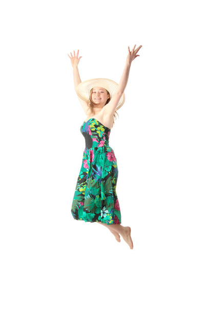 Happy young blond woman in summer colorfull dress jumping, isolated on white - Foto, afbeelding