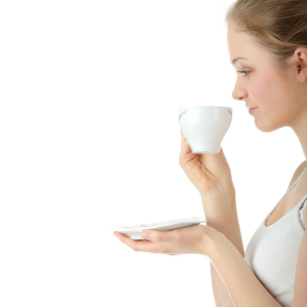 Young attractive blond woman drinking coffee, isolated on white background  - Zdjęcie, obraz