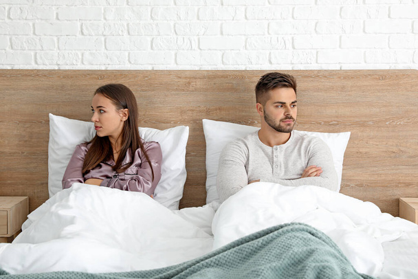 Sad couple after quarrel in bedroom - Foto, imagen