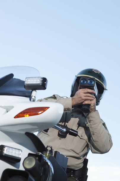 Officer looking through speedometer - Fotó, kép