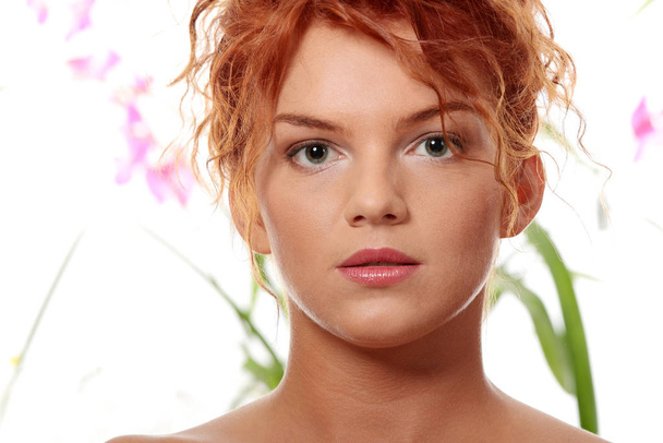 Close-up portrait of sexy caucasian young redhead woman against natural green background - Foto, immagini