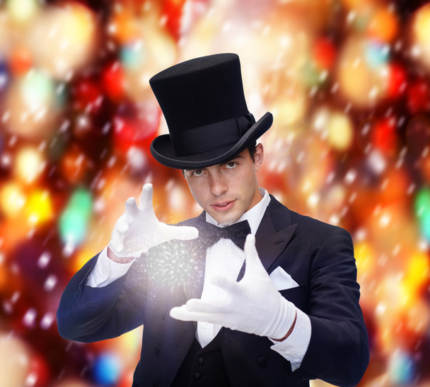Magician in top hat showing trick - Valokuva, kuva
