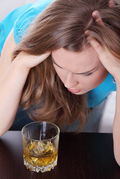 Young corpulent woman in depression, drinking alcohol  - Фото, изображение