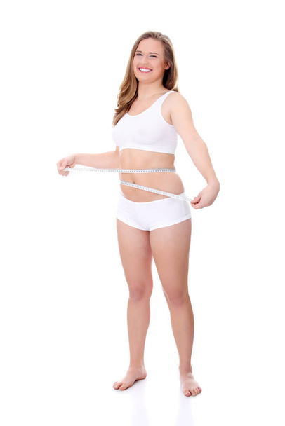 Female measuring her body, isolated on white  - Φωτογραφία, εικόνα