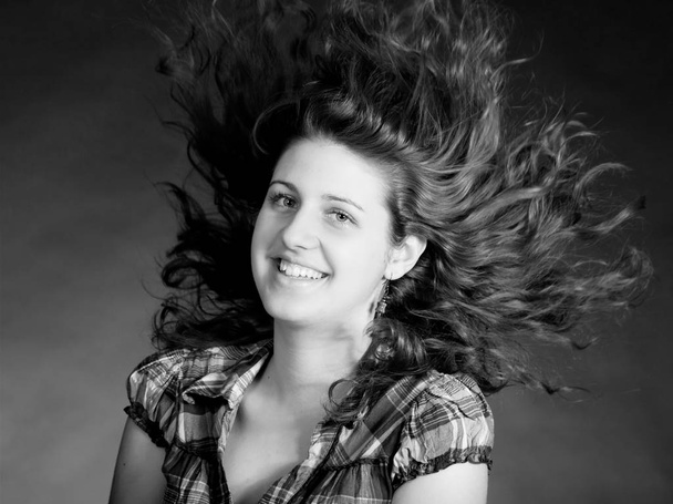 young brunette woman with long flying hair, studio shot - Фото, зображення
