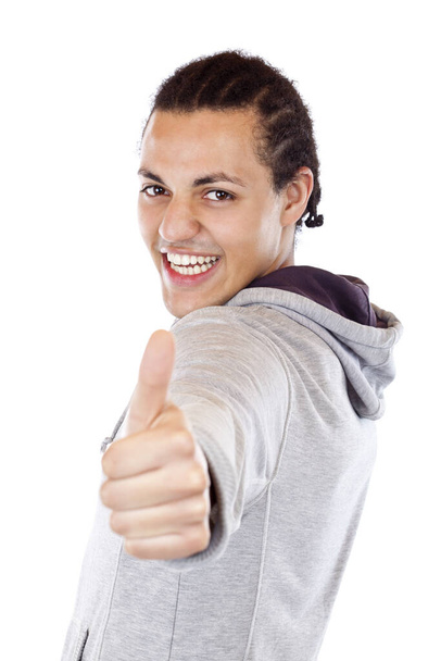 sporty dark-skinned teenager holds thumbs up. freelance on white background. - Фото, изображение