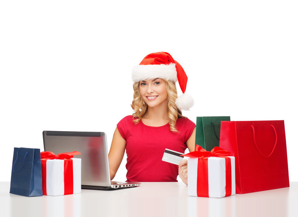 Woman with gifts, laptop computer and credit card - Foto, immagini