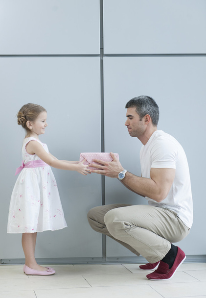 Девушка вручает подарок отцу
 - Фото, изображение
