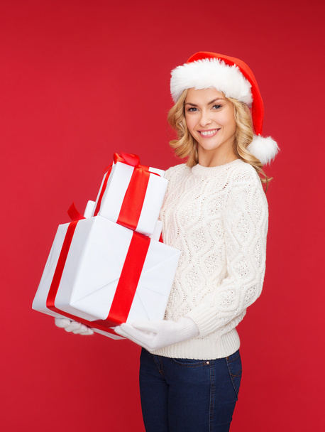 Woman in santa helper hat with many gift boxes - Zdjęcie, obraz