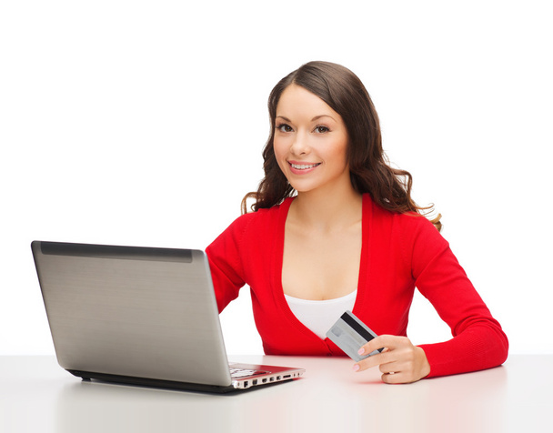 Happy woman with laptop computer and credit card - 写真・画像