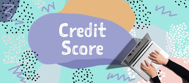 Credit score theme with person using laptop - Фото, зображення