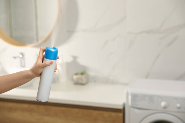 Woman spraying air freshener in bathroom, closeup - Zdjęcie, obraz