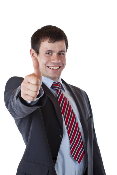 successful young business man is holding thumbs up. isolated on white background. - Foto, Imagen
