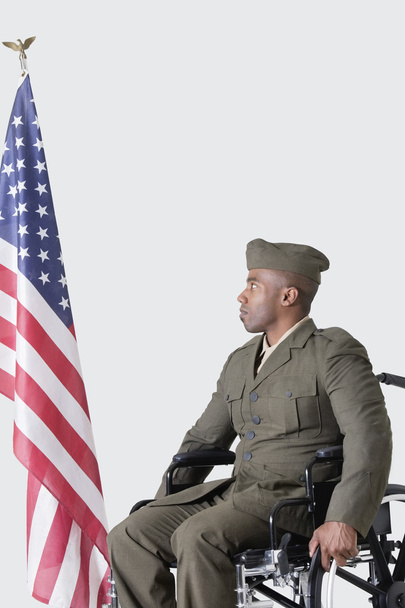 Soldier in wheelchair looking at American flag - Φωτογραφία, εικόνα