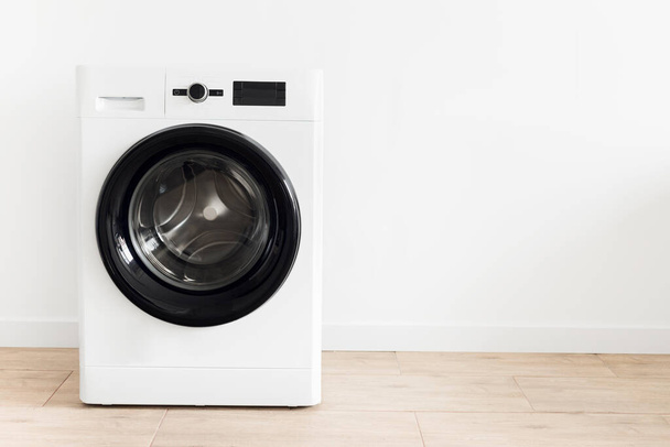 White laundry room with a washing machine Copy space - Zdjęcie, obraz