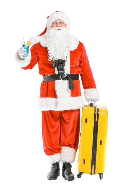 Père Noël avec bagage et cocktail sur fond blanc. Concept de vacances
 - Photo, image