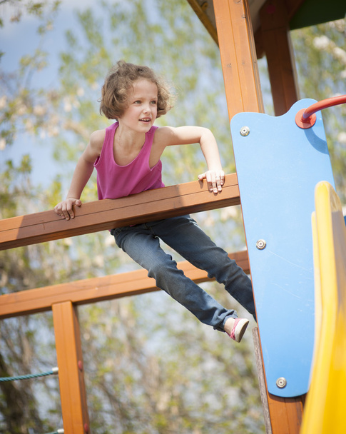 Girl climbing on playground - Foto, imagen